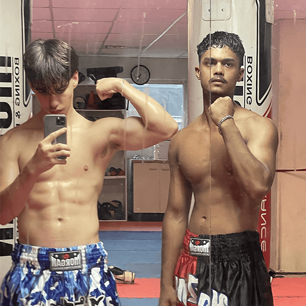 Van and a training partner flexing in a boxing gym